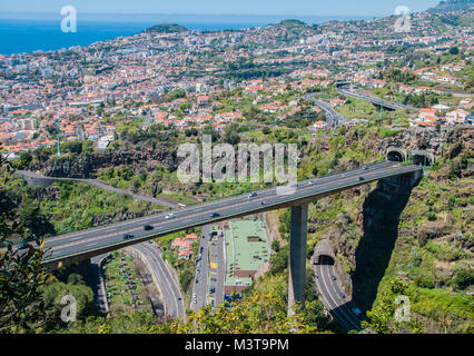 A view of Madeira`s  network of roads and tunnels taken high up from a cable car over Funchal Madeira. Stock Photo